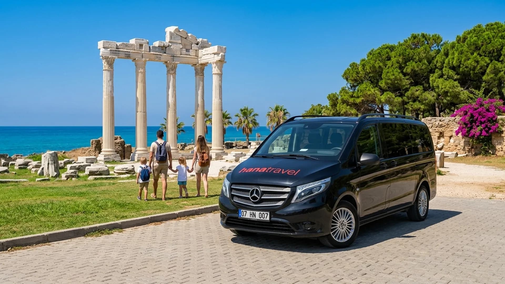 Two thousand years of Side, a short walk from the car Family walking from the black Hana Travel Vito towards the marble columns of the Temple of Apollo on the Side peninsula — Side taxi transfer